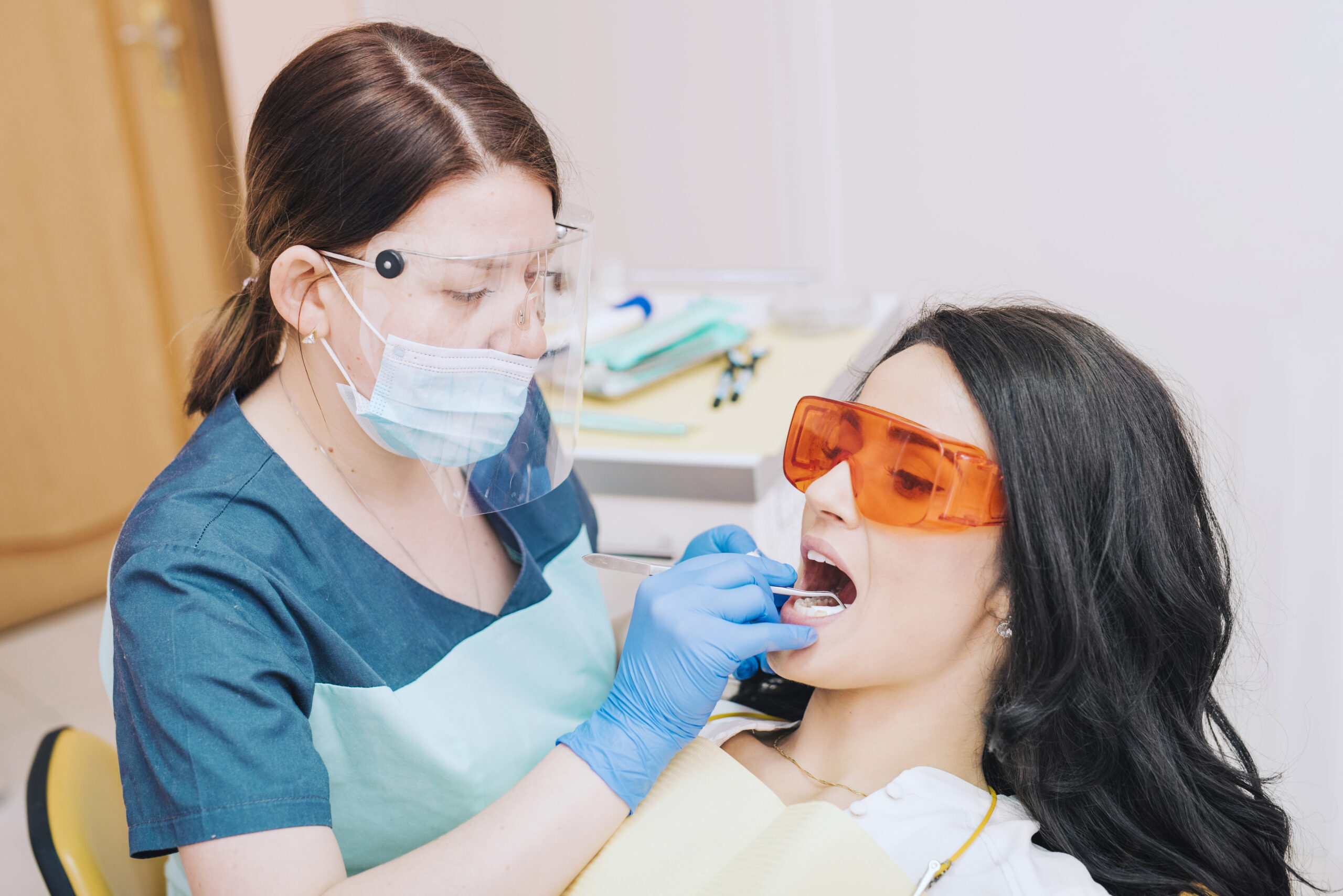 Dentist examining gums for gum disease at a Grants NM dental office
